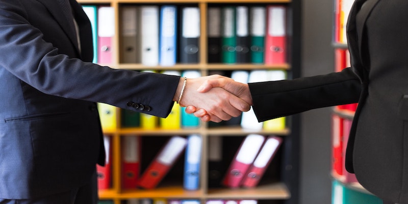 photo of two people shaking hands