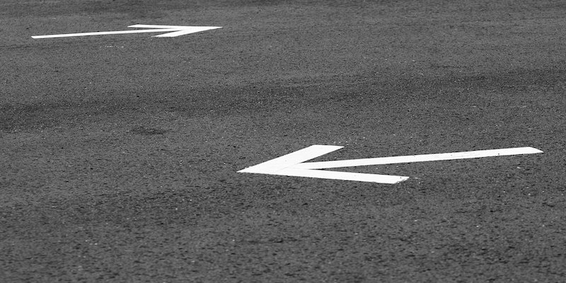 two arrows painted on a road